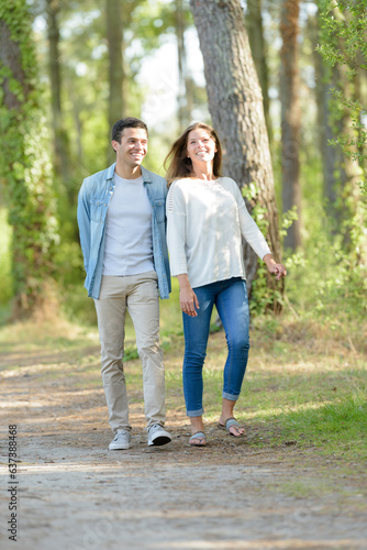 a couple walking in forest