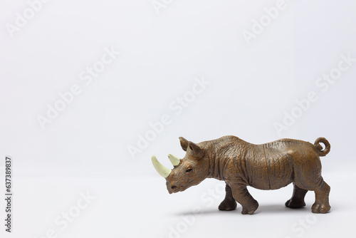 Fototapeta Naklejka Na Ścianę i Meble -  a plastic toy rhinoceros on a white background