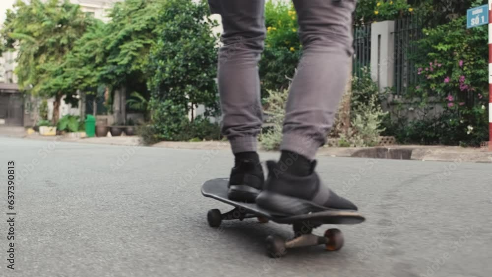 Cropped shot of legs of man enjoying his skateboard ride on street Cropped shot of legs of man enjoying his skateboard ride on street
