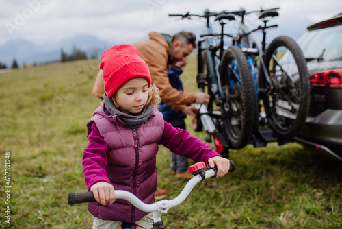 Young girl looking forward to bicycle ride in nature.