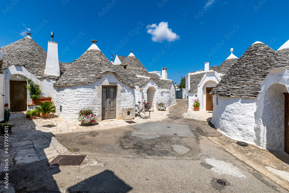 Alberobello, Italy - July 21, 2021: The Trulli of Alberobello in Apulia in Italy. These typical houses with dry stone walls and conical roofs are unique to the world