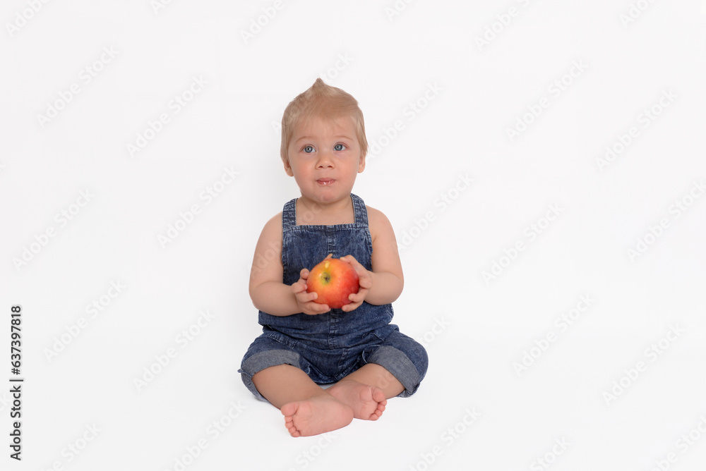 Lovely 10 months baby with apple on white background Lovely 10 months baby with apple on white background