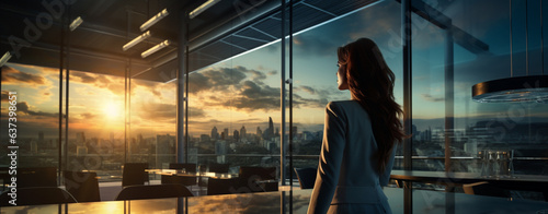 women in an empty office looking at the sunset over the city, legal AI © PETR BABKIN