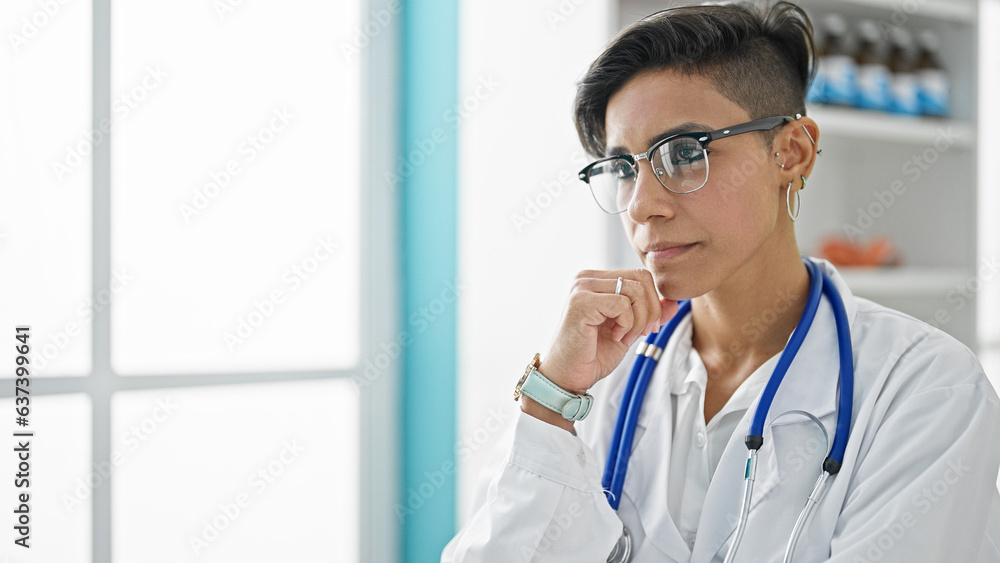 Young beautiful hispanic woman doctor standing stressed at clinic Young beautiful hispanic woman doctor standing stressed at clinic