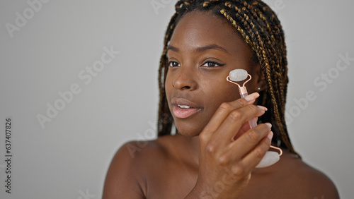 Wallpaper Mural African american woman massaging face with skin gym over isolated white background Torontodigital.ca