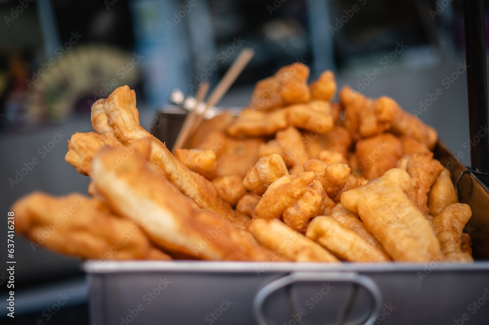 Deep-fried Patongo is a fried Chinese food served with coffee in a market in Yaowarat, Bangkok, Thailand.