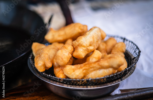 Deep-fried Patongo is a fried Chinese food served with coffee in a market in Yaowarat, Bangkok, Thailand.
