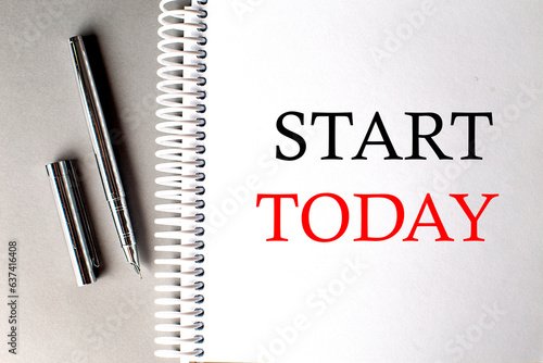 START TODAY text on a notebook with pen on grey background