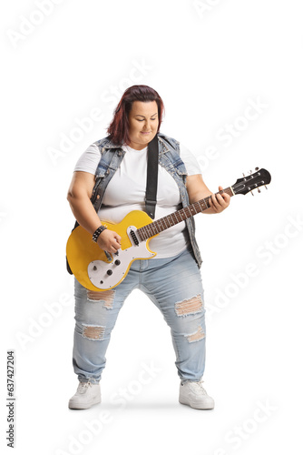 Corpulent young woman playing an electric guitar