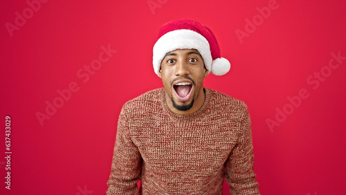 Принти на полотні African american man surprise expression wearing christmas hat over isolated red