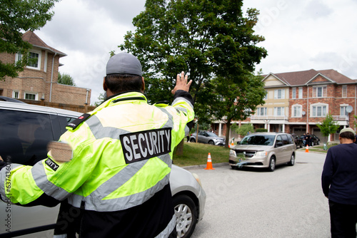 Security guard controlling traffic on busy street