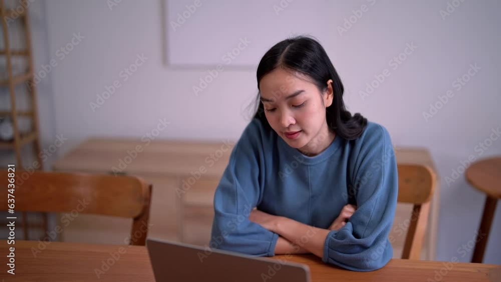 stressed Asian business woman think of problem solution and tired from working on laptop at home. stressed Asian business woman think of problem solution and tired from working on laptop at home.