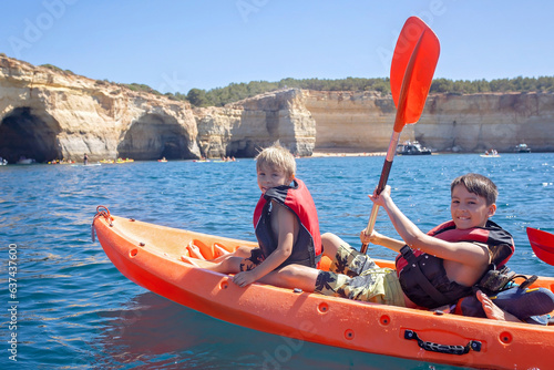 Children, enjoying Benagil, Portugal. Benagil Cave inside Algar de Benagil, famous sea cave in Algarve coast, Lagoa.