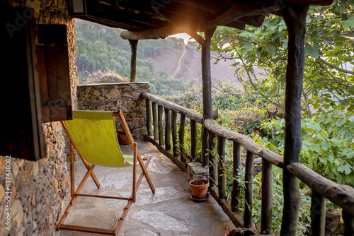 Beautiful medieval village Talasnal in Lousa, Portugal on a beautiful day. Child playing on the street of the village with his pet dog