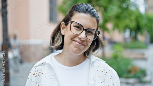 Photography Beautiful young hispanic woman smiling confident in the streets of Stockholm