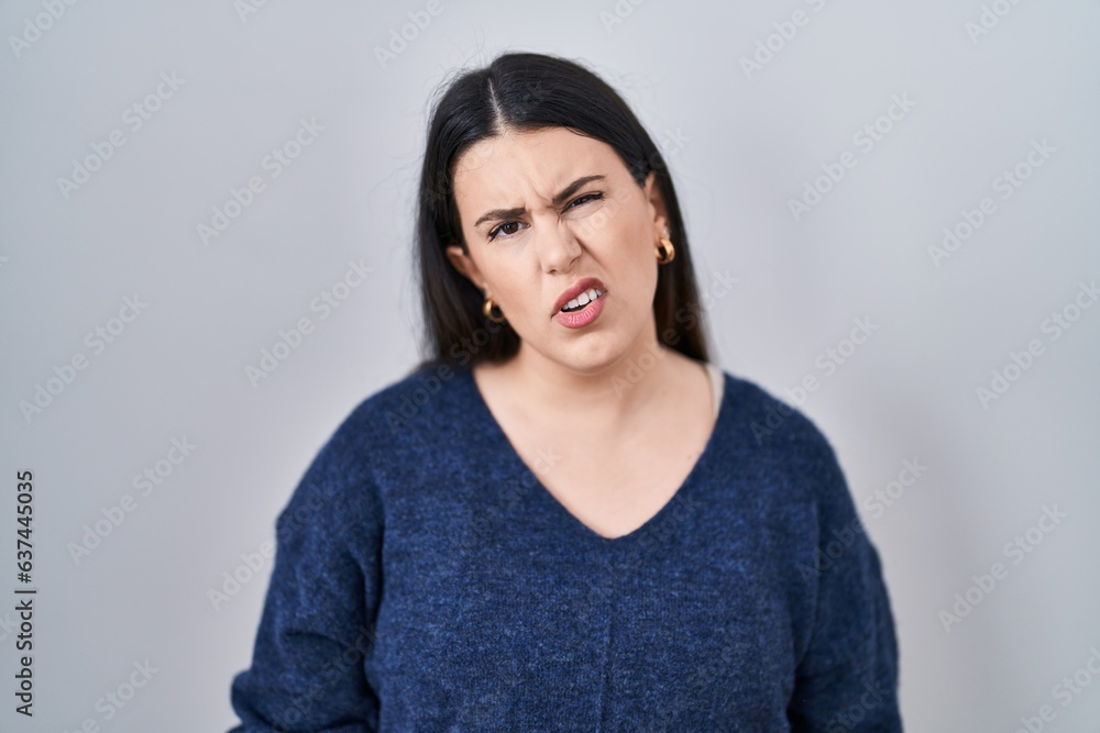 Young brunette woman standing over isolated background looking sleepy and tired, exhausted for fatigue and hangover, lazy eyes in the morning. Young brunette woman standing over isolated background looking sleepy and tired, exhausted for fatigue and hangover, lazy eyes in the morning.