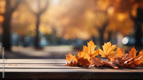 Autumn leaves on a wooden table in the park. Autumn background