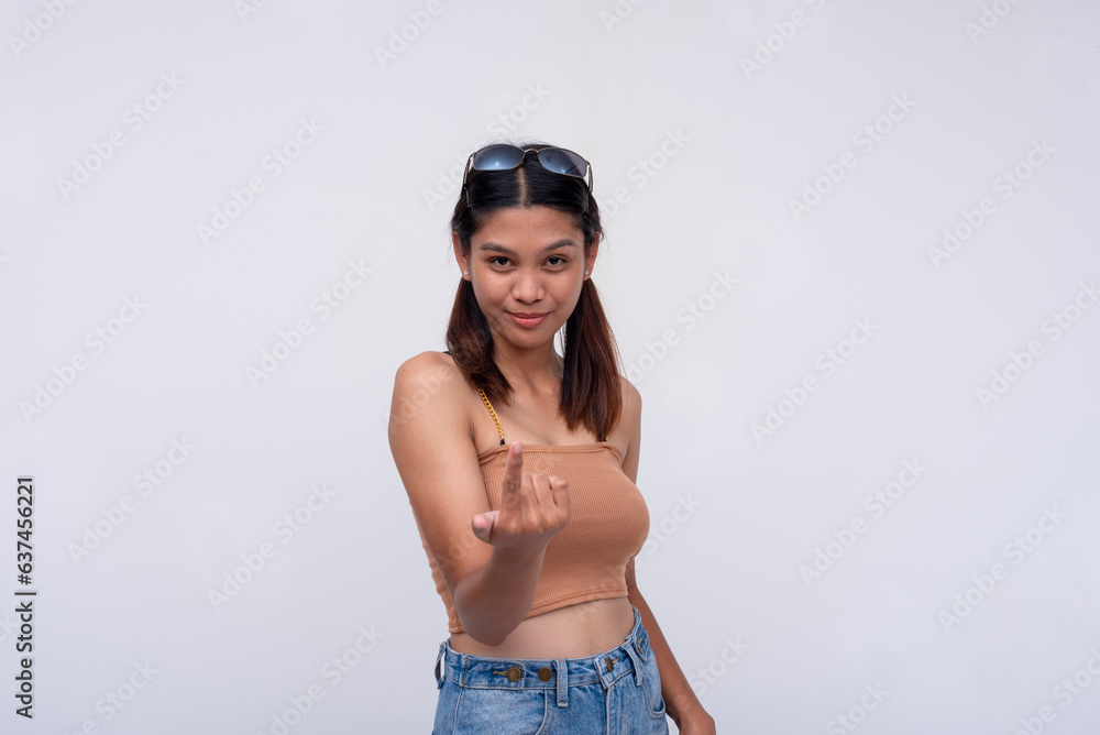 A confident young asian woman invites someone to come closer for an interaction. Isolated on a white background. A confident young asian woman invites someone to come closer for an interaction. Isolated on a white background.
