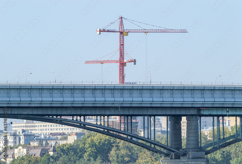 Metro Bridge on the Background of the City and Construction Cranes