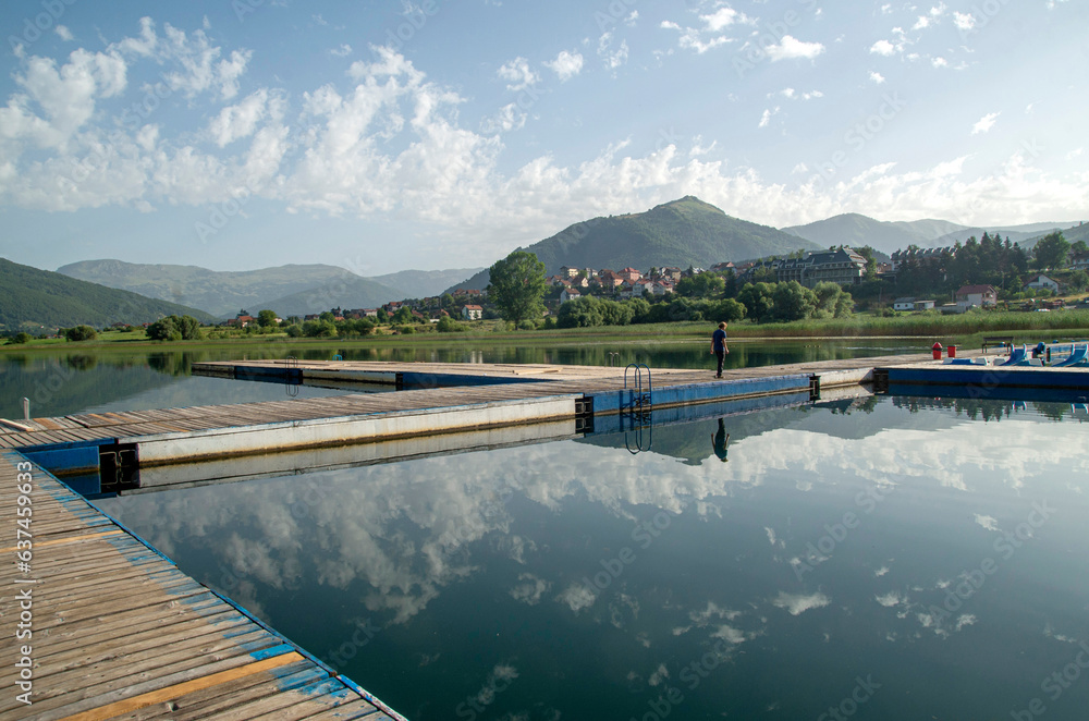 Naklejka premium Lake Plav with wooden pier and boats for walking and fun in Montenegro, Europe