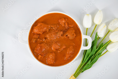 Tasty butter chicken curry dish from Indian cuisine. Tasty butter chicken curry or Murg Makhanwala or masala. Butter chicken tikka masala served with roti / Paratha photo