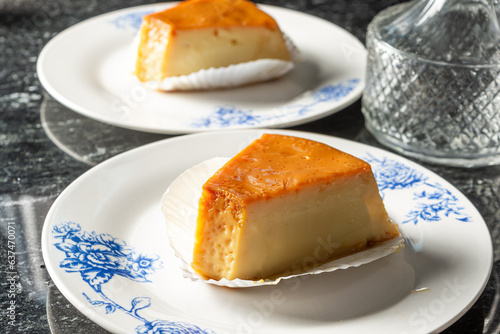 pudim or pudding, two slices of pudding on a white plate, delicious gourmet. also known as flan