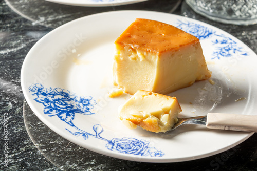 pudim or pudding and a spoon, gourmet homemade dessert. traditional brazilian food known also as flan photo