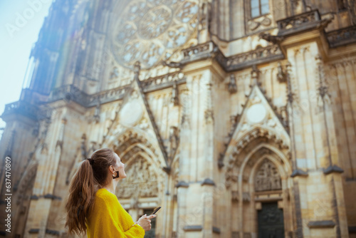 woman in Prague having walking tour and using smartphone