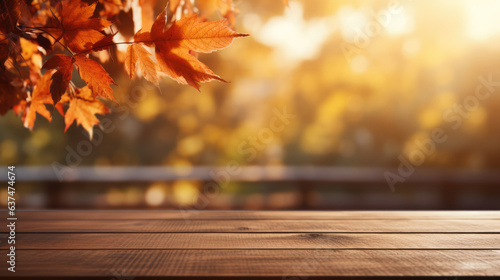 Image of wooden table with autumn leaves and trees