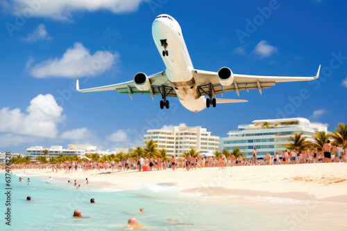 Plane landing in an airport situated near a beach crowded of people. 