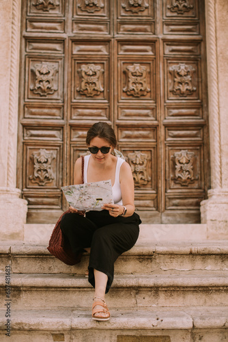 Female tourist with city ma...