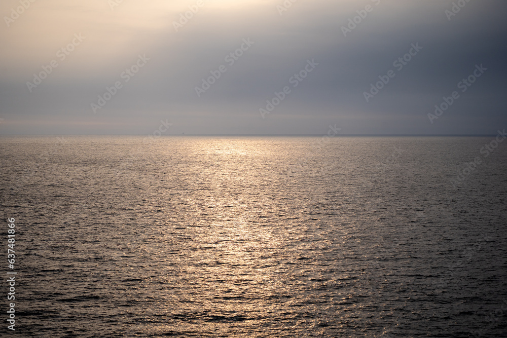 picture of sea and sky During the sunrise and sunset There will be sunlight reflecting on the water surface in orange color.