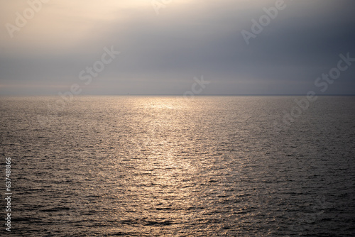 picture of sea and sky During the sunrise and sunset There will be sunlight reflecting on the water surface in orange color.