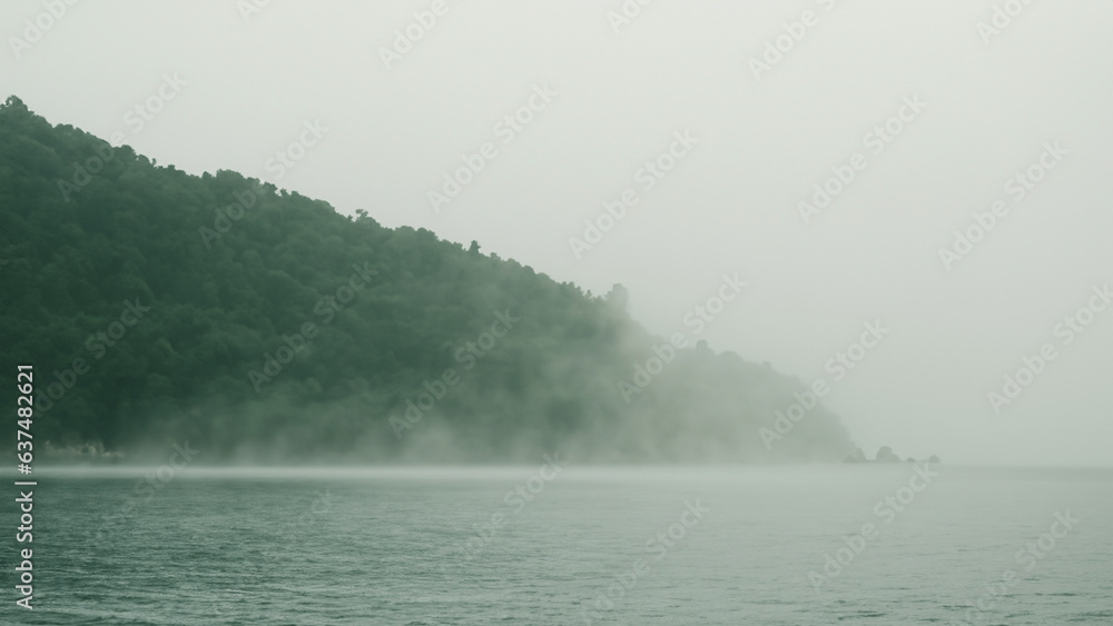 The sea hills and sand are covered with fog and spray scary mystery ocean and mountains Tourist attraction 3d illustration The sea hills and sand are covered with fog and spray scary mystery ocean and mountains Tourist attraction 3d illustration