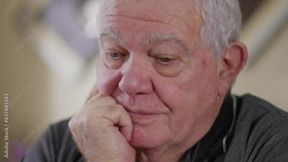 Pensive senior man close-up face with hand in chin in deep thought. Contemplative gaze of an elderly person in 70s Pensive senior man close-up face with hand in chin in deep thought. Contemplative gaze of an elderly person in 70s