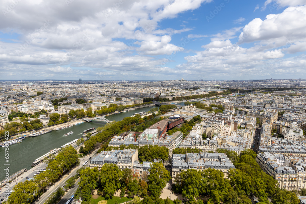 Aerial view of Paris the Seine with clouds trees blue and green