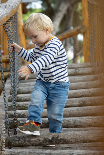 Little boy walking down the stairs on the playground © KONSTANTIN SHISHKIN