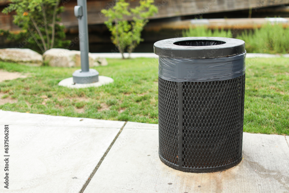 Foto de Lonely trashcan on urban street Symbolizes waste, consumption