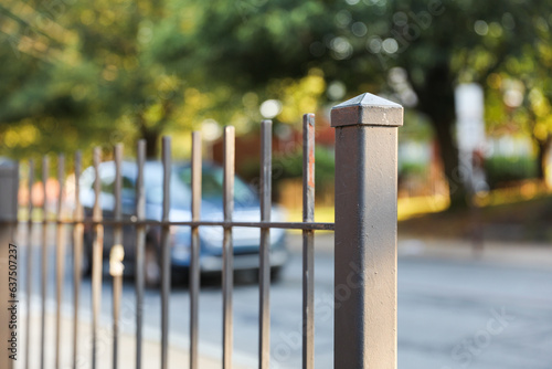 Metal fence: Symbol of boundaries and security; conveys separation and protection. Metaphor for division and safeguarding spaces. Stark, functional photo