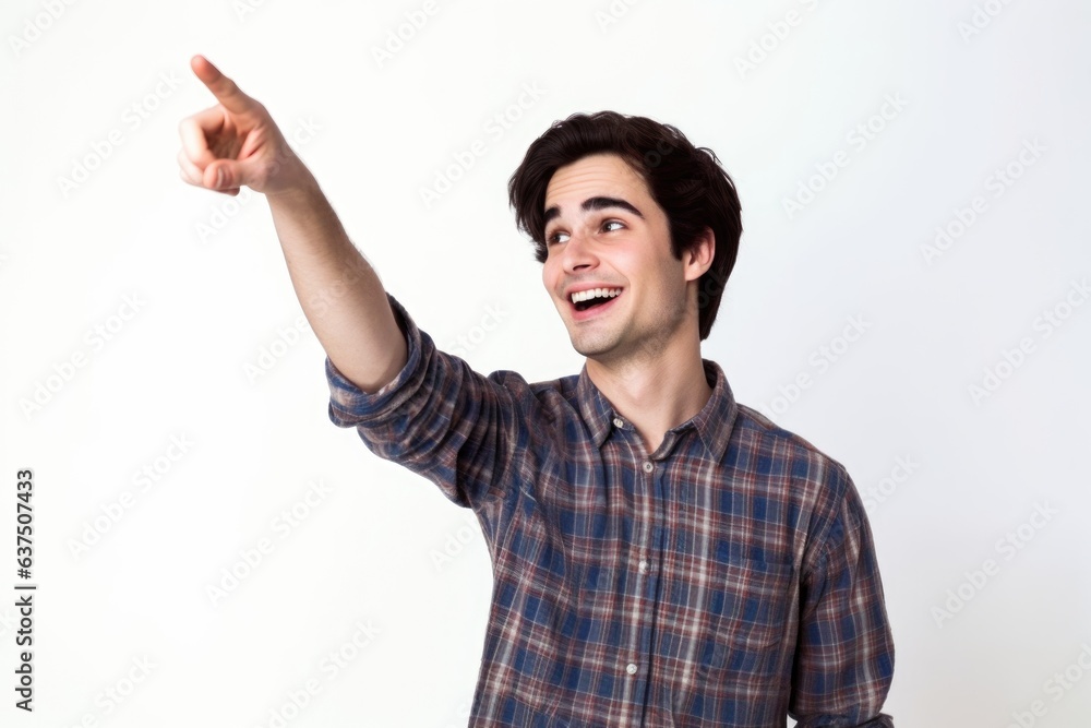studio shot of a casual young man pointing upwards against a white background studio shot of a casual young man pointing upwards against a white background