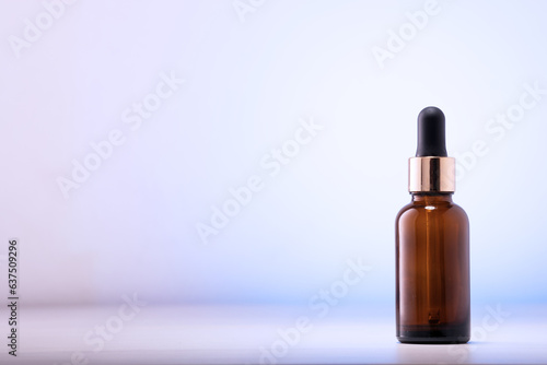 One dark amber glass cosmetic bottle on the table. Close-up, copywriting. Beauty blog, salon treatment concept, minimalist brand packaging mockup