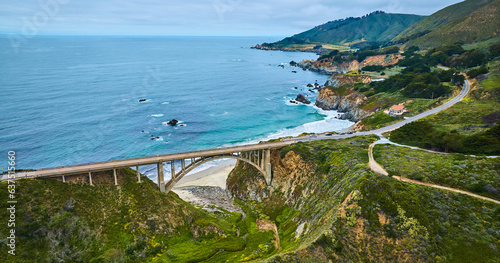 Scenic aerial side view of Highway One Rocky Creek Bridge with ocean and coastline view