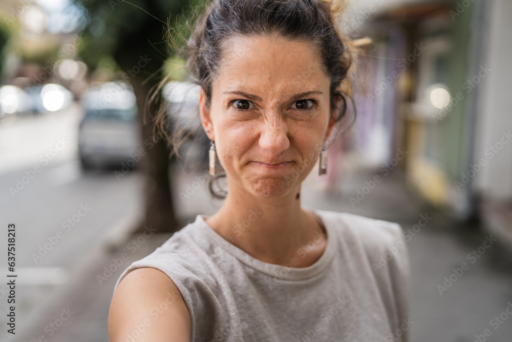 Portrait of adult caucasian woman stand in town or city outdoor in day Portrait of adult caucasian woman stand in town or city outdoor in day