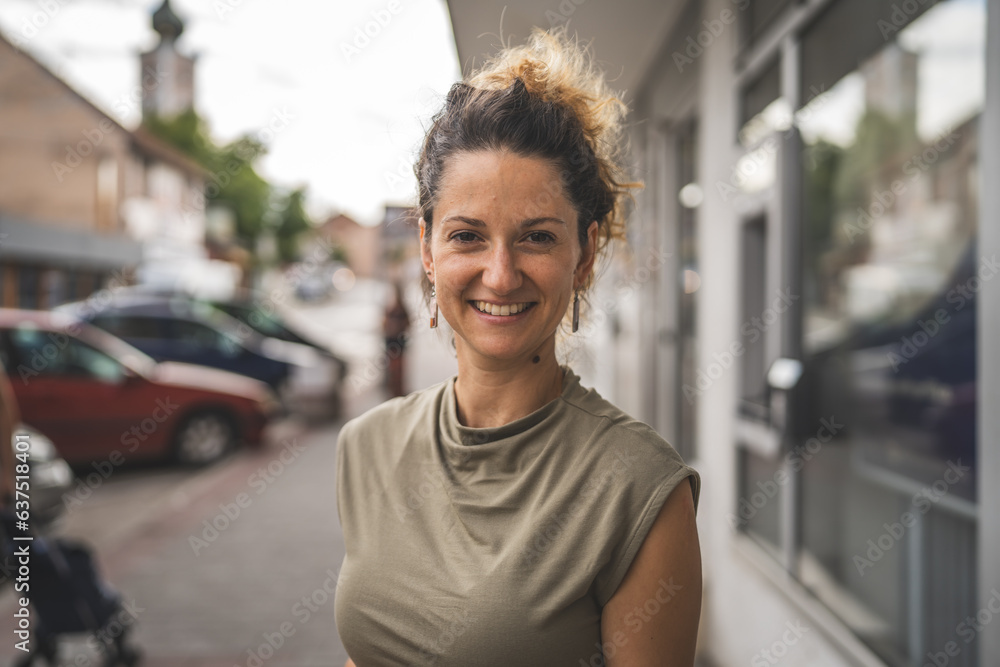 Portrait of adult caucasian woman stand in town or city outdoor in day Portrait of adult caucasian woman stand in town or city outdoor in day