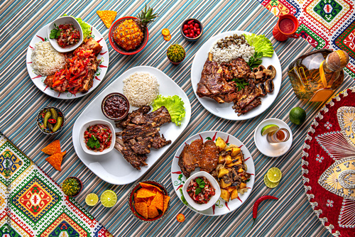 Traditional mexican food. Assortment of meat dishes from lamb: ribs, stew, clipping, barbecue. Colorful Food Table Celebration Delicious Party Meal Concept. 