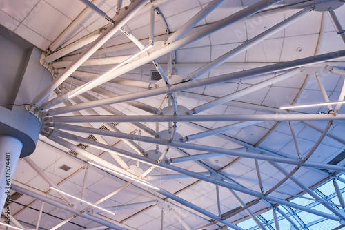 Close up of clean white ceiling with thick white beams and air duct vents