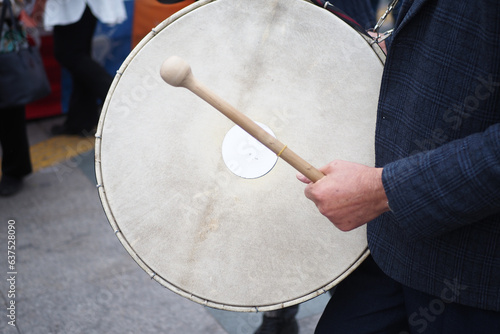 A man hit the ancient drum with Musical Instrument.