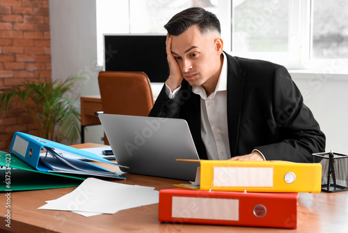 Stressed businessman workin...