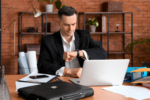 Stressed businessman workin...