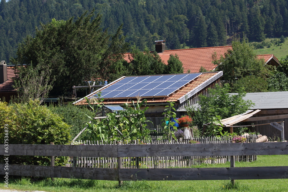 house panels on the roof of a private house with solar panels on the roof, the concept of renewable energy